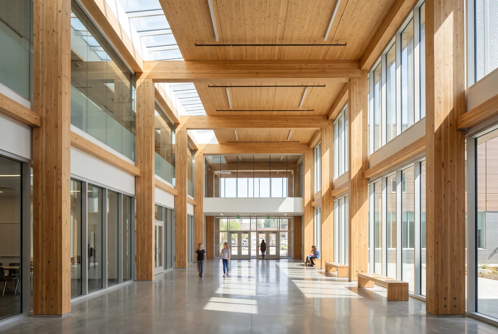 Timber-framed atrium interior with floor-to-ceiling glazing