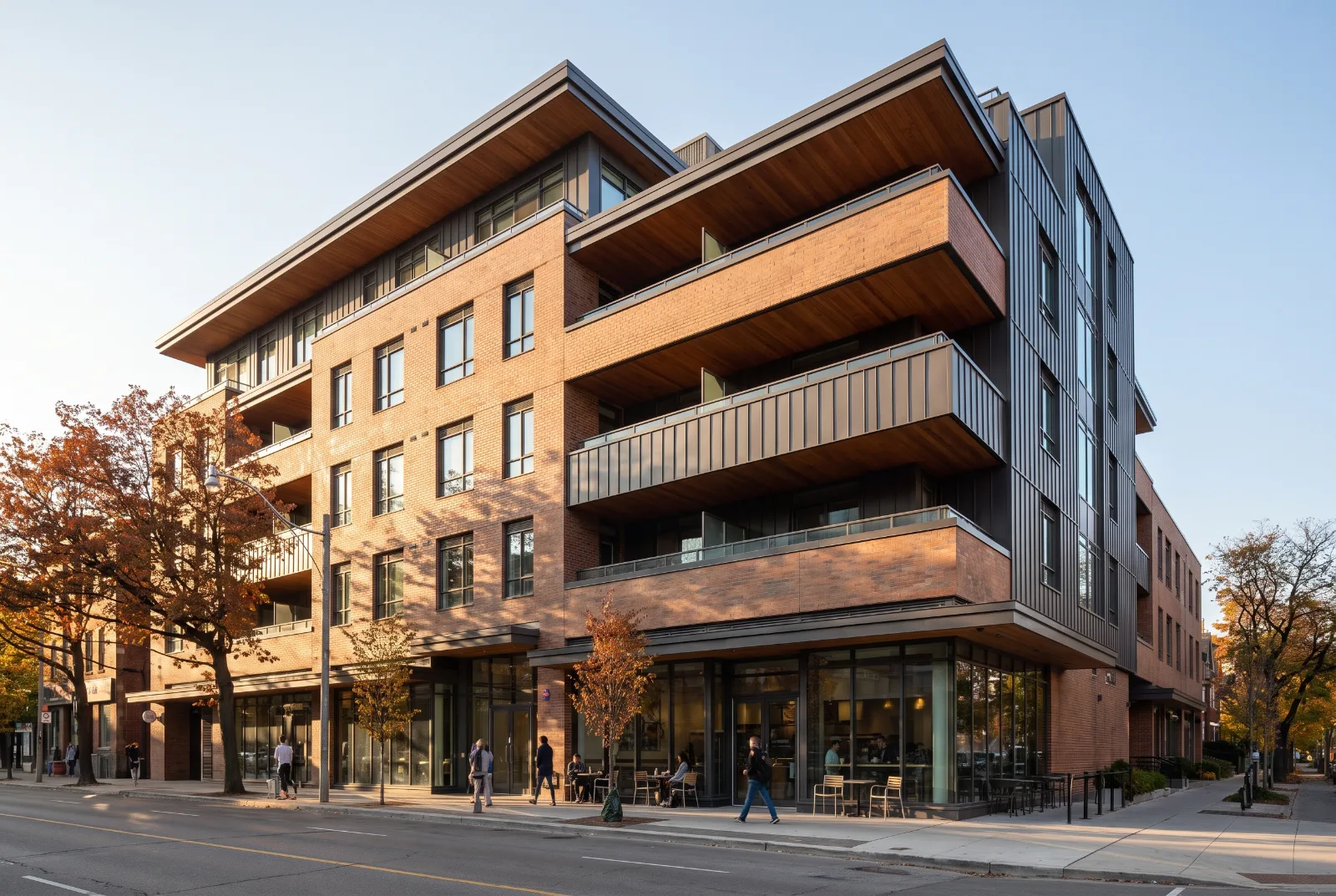 Brick mid-rise apartment building with balconies in autumn light