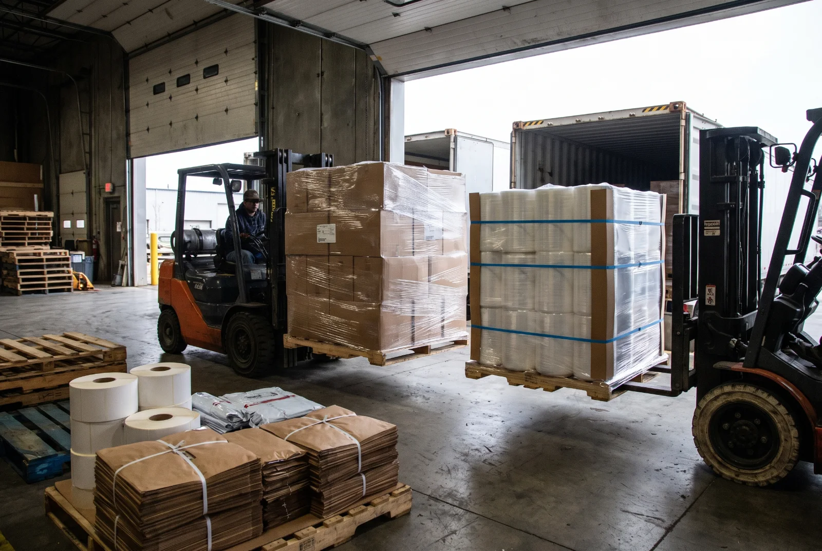 Shipping dock at a packaging manufacturer with stretch-wrapped, strapped pallets being loaded