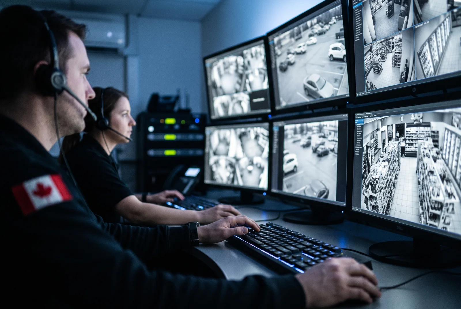 Operators in an alarm monitoring station watching video feeds